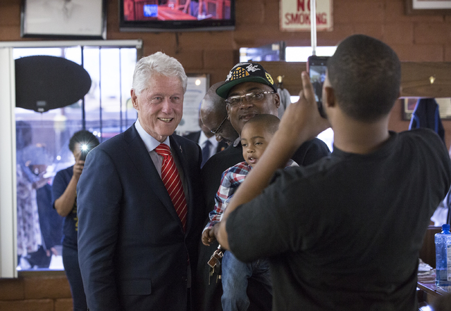 Former President Bill Clinton takes photos with supporters at Hair Unlimited on Thursday, Nov. 3, 2016, in Las Vegas. President Clinton was in Las Vegas for a rally at Cox Pavilion for his wife, D ...