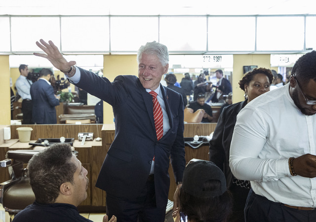 Former President Bill Clinton waves to patrons at Hair Unlimited on Thursday, Nov. 3, 2016, in Las Vegas. President Clinton was in Las Vegas for a rally at Cox Pavilion for his wife, Democratic pr ...