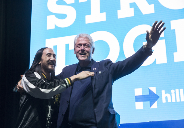 Former President Bill Clinton, right, and musician/philanthropist Steve Aoki interact with the crowd at a rally at Cox Pavilion on Thursday, Nov. 3, 2016, at UNLV, in Las Vegas. The event was a ca ...