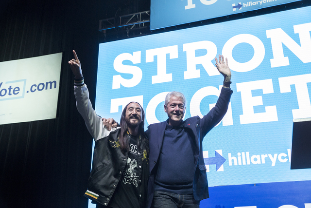 Former President Bill Clinton, right, and musician/philanthropist Steve Aoki interact with the crowd at a rally at Cox Pavilion on Thursday, Nov. 3, 2016, at UNLV, in Las Vegas. The event was a ca ...