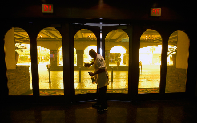 A hotel maintenance worker keeps the front doors at the El Cortez clean on Thursday, Oct. 27, 2016, in Las Vegas. The family-owned downtown institution is celebrating its 75th anniversary. It orig ...