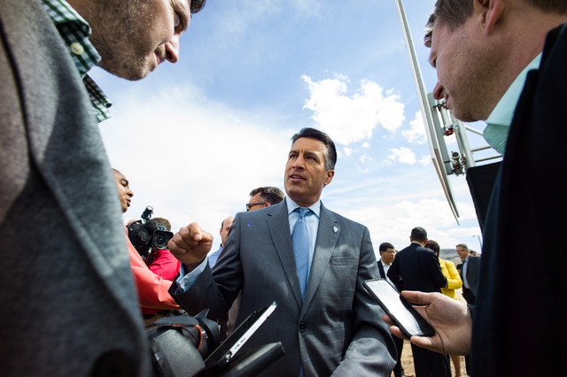 Gov. Brian Sandoval speaks with reporters following the groundbreaking for the Faraday Future's planned 900-acre manufacturing site in North Las Vegas on Wednesday, April 13, 2016. Chase Stevens/L ...