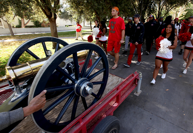 Members of the UNLV football team follow the Fremont Cannon as it makes its way through the UNLV campus in Las Vegas on Monday, Oct. 28, 2013.(Justin Yurkanin/Las Vegas Review-Journal)