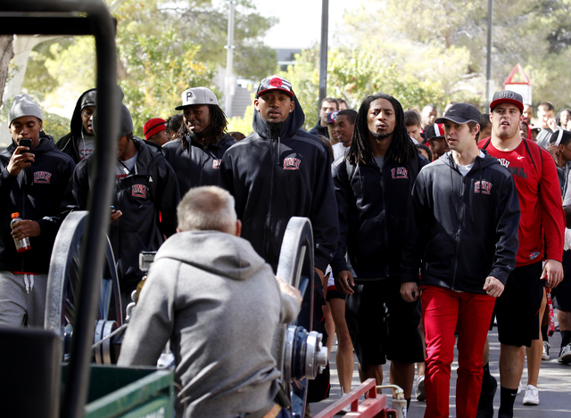 Members of the UNLV football team follow the Fremont Cannon as it makes its way through the UNLV campus in Las Vegas on Monday, Oct. 28, 2013.(Justin Yurkanin/Las Vegas Review-Journal)