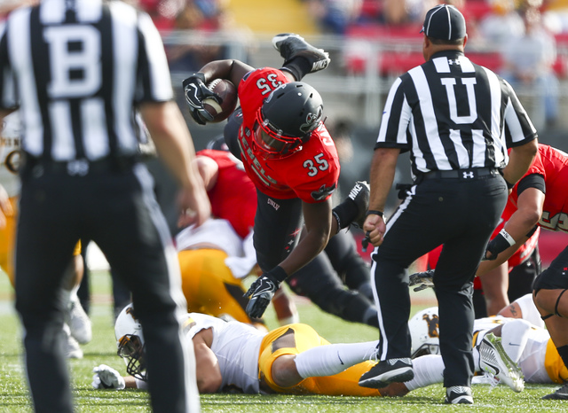 UNLV running back Xzaviar Campbell (35) is tripped up during a football game against Wyoming at Sam Boyd Stadium in Las Vegas on Saturday, Nov. 12, 2016. (Chase Stevens/Las Vegas Review-Journal) F ...