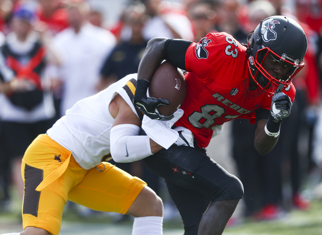 UNLV wide receiver Devonte Boyd (83) is tackled by Wyoming defensive back Marcus Epps (6) during a football game at Sam Boyd Stadium in Las Vegas on Saturday, Nov. 12, 2016. (Chase Stevens/Las Veg ...