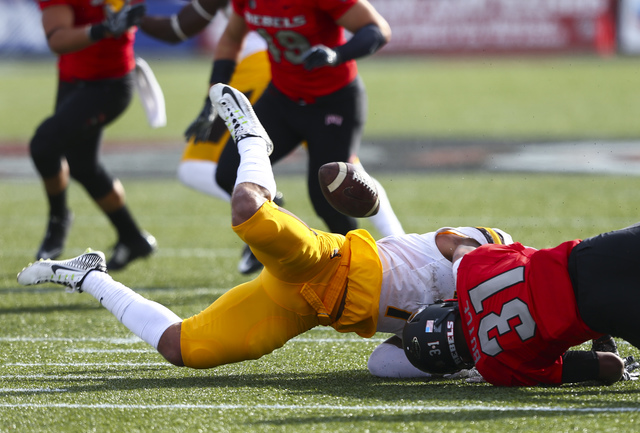 Wyoming linebacker D.J. May (7) fumbles the ball as UNLV defensive back Salah Boyce (31) makes the tackle during a football game at Sam Boyd Stadium in Las Vegas on Saturday, Nov. 12, 2016. UNLV g ...