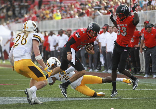 UNLV quarterback Kurt Palandech (14) runs the ball during a football game against Wyoming at Sam Boyd Stadium in Las Vegas on Saturday, Nov. 12, 2016. UNLV defeated Wyoming 69-66 in triple overtim ...