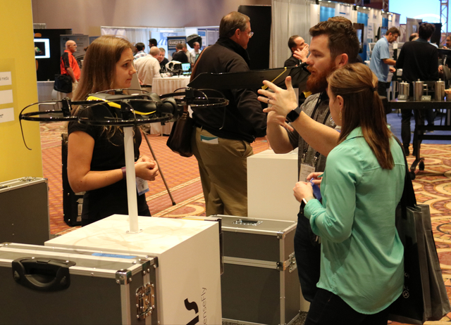 Julie Foguenne (left) with Sensefly speaks with Emily Porche and Cody Porche of Porche Aerial Imagery about the Albris drone, made for inspections, during the Commercial UAV Expo at the MGM Grand  ...