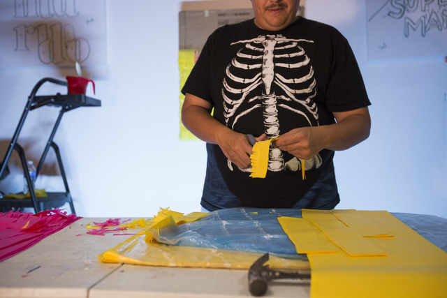 Working on a commissioned piece, artist Justin Favela hand-cuts strips of tissue paper inside his studio at the Juhl in downtown Las Vegas. Richard Brian/Las Vegas Review-Journal Follow @vegasphot ...