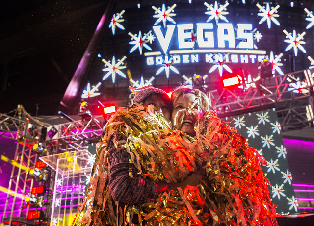 Janice Palmaffy, left, and Jaleen Baumgart celebrate at the conclusion of a ceremony to unveil the Las Vegas' NHL expansion franchise's official team nickname, logos and colors on Tuesday, Nov. 22 ...