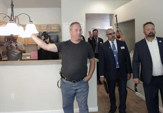 U.S. Army Cpl. Christopher Hudson, left, tours his newly renovated home Oct. 14, 2016. Bizuayehu Tesfaye/Las Vegas Review-Journal Follow @bizutesfaye