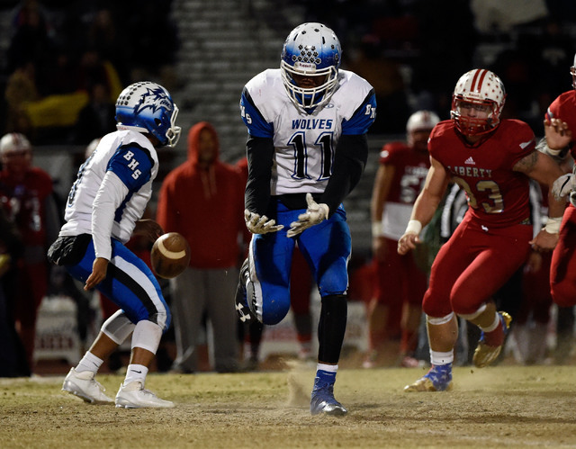 Basic's Frank Harris (11) drops the ball after a hand off by quarterback Aaron McAllister during a high school football game against Liberty at Liberty High School Friday, Nov. 18, 2016, in Hender ...