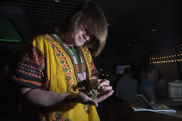 Pro marijuana supporter Justin Gwinn looks at his strain of marijuana during the Las Vegas Weekly's Question 2 watch party inside the Sake Rok restaurant in Las Vegas on Tuesday, Nov. 8, 2016. Mar ...