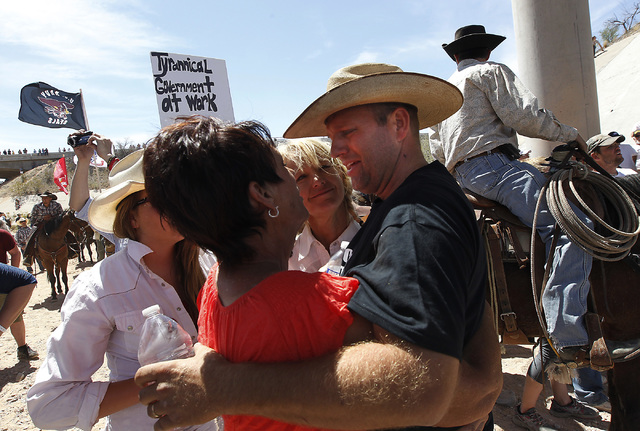 Ammon Bundy, right, son of rancher Cliven Bundy, hugs some of his family's supporters after the BLM agreed to release his family's a cattle near Bunkerville on April 12, 2014. (Jason Bean/Las Vega ...