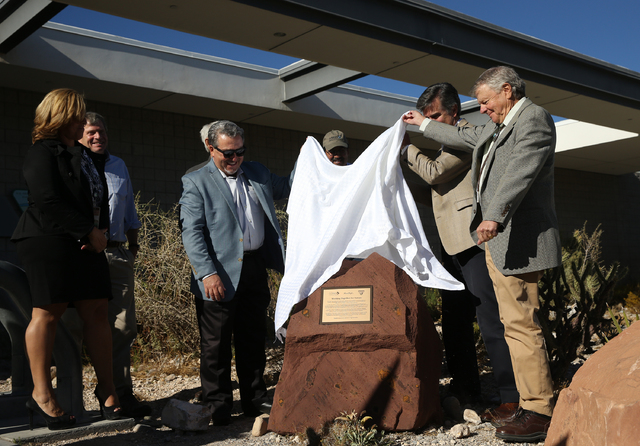 Joel Laub, right, chairman of the board of trustees for the Nature Conservancy, unveils a new monument celebrating the organization, as well as the Bureau of Land Management and Summerlin develope ...