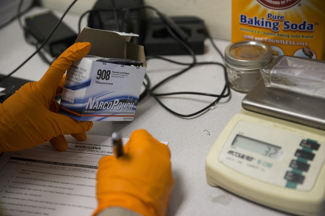 Las Vegas police officer Manuel Papazian uses a drug test kit to confirm for marijuana at the Las Vegas Metropolitan Police Department Downtown Area Command on Saturday, Oct. 8, 2016, in Las Vegas ...