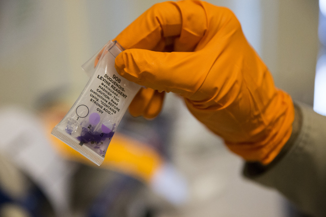 Las Vegas police officer Manuel Papazian uses a drug test kit to confirm for marijuana at the Las Vegas Metropolitan Police Department Downtown Area Command on Saturday, Oct. 8, 2016, in Las Vegas ...