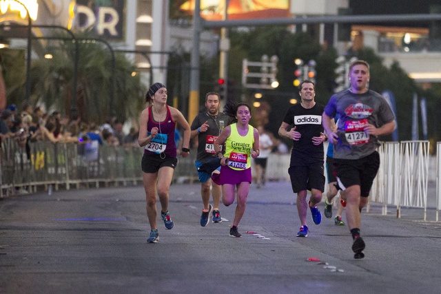 Runners in the 10K run make their way to the finish line in the Rock ‘n’ Roll Marathon at the Strip near The Mirage on Sunday, Nov. 13, 2016, in Las Vegas. (Erik Verduzco/Las Vegas Review-Journal)