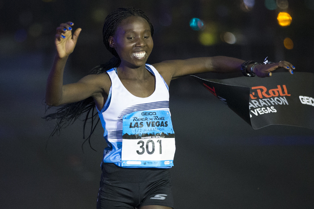 Elvin Kibet completes the half-marathon run in first place for women during the annual Rock ‘n’ Roll Marathon at the Strip near The Mirage hotel-casino on Sunday, Nov. 13, 2016, in L ...