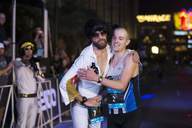 First place runner Michael Wardian, left, and third place runner Chip O'hara, embrace after the Rock-n-Roll Marathon at the Strip near The Mirage hotel-casino on Sunday, Nov. 13, 2016, in Las Vega ...