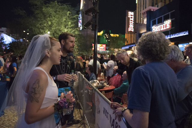 Kelsey Vallentine, left, and Monty Montague, second from left, of New Mexico greet family members as they prepare to get married during the Rock 'n' Roll Marathon's  Ҳun-thruӠweddings  ...