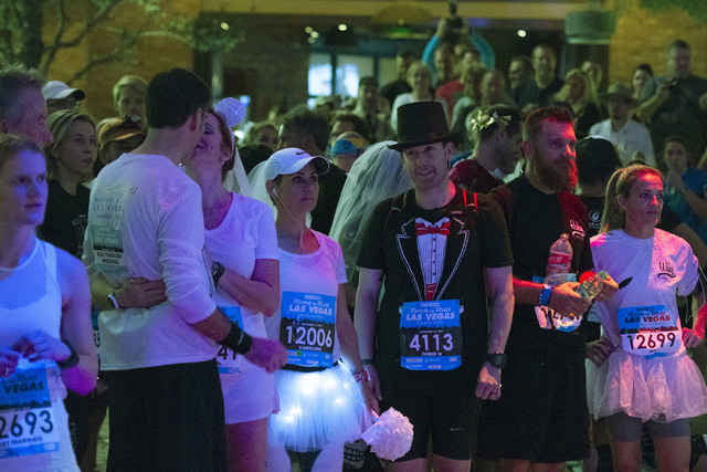 Couple wait to be married during the Rock 'n' Roll Marathon's “run-thru” weddings at The Park in Las Vegas, Sunday, Nov. 13, 2016. More than 200 couples participate, most renewing th ...