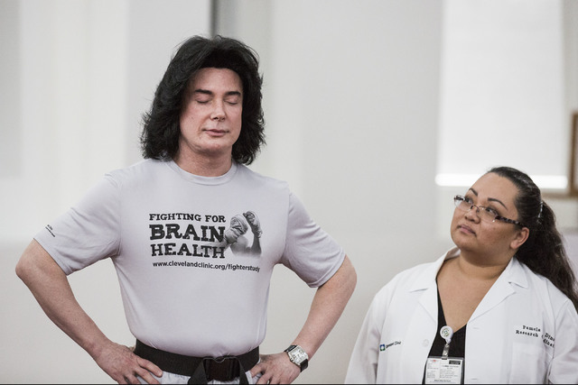 Pamela Dino, right, research coordinator for Cleveland Clinic Lou Ruvo Center for Brain Health, monitors entertainer Frank Marino during a balance test on Monday, Nov. 15, 2016. The facility is lo ...