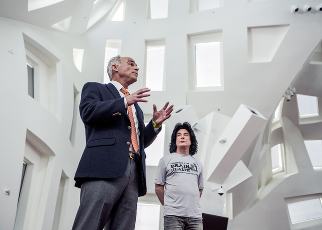 Dr. Charlie Bernick, associate medical director for Cleveland Clinic Lou Ruvo Center for Brain Health, speaks during a news conference on Monday, Nov. 15, 2016. In the background is entertainer F ...
