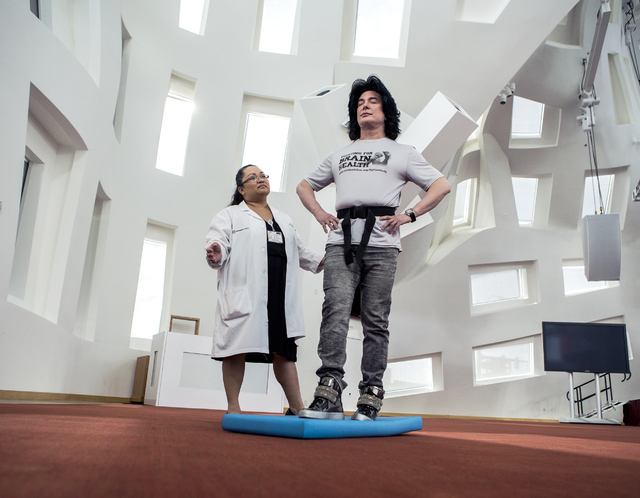 Pamela Dino, left, research coordinator for Cleveland Clinic Lou Ruvo Center for Brain Health, monitors entertainer Frank Marino during a balance test on Monday, Nov. 15, 2016. The facility is loo ...