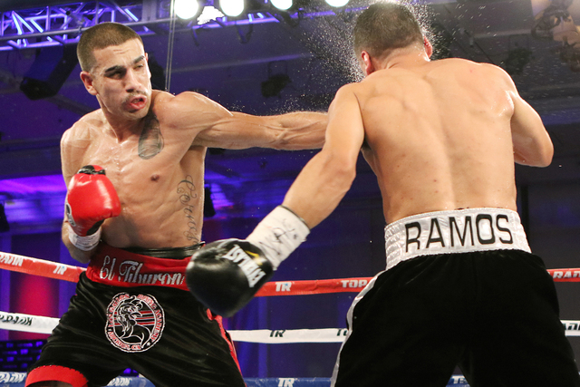 Andy Vences, left, of San Jose, hits Casey Ramos, of Austin, Tex., during a super featherweight boxing bout at T.I. hotel-casino Friday, Nov. 4, 2016, in Las Vegas. Vences won by unanimous technic ...