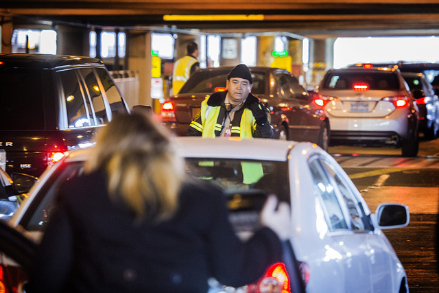 Ground transit technician Eduardo Dorantes directs traffic in passenger pick up at McCarran International Airport on Wednesday, Nov. 25, 2015. (Jeff Scheid/ Las Vegas Review-Journal) Follow @jlscheid