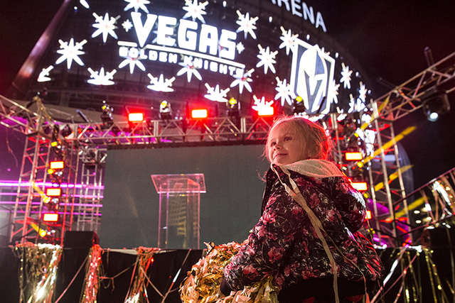 Hannah McKinley plays with gold streamers at the conclusion of a ceremony to unveil the Las Vegas' NHL expansion franchise's official team nickname, logos and colors on Tuesday, Nov. 22, 2016, at  ...
