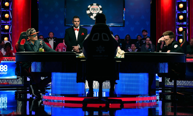 Gordon Vayo, right, of San Francisco ponders to call an all-in bet by Qui Nguyen of Las Vegas during the final table at the 2016 World Series of Poker Main Event at the Rio hotel-casino, Tuesday, ...