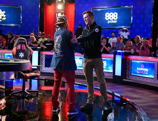 Qui Nguyen, left, of Las Vegas is congratulated by Gordon Vayo of San Francisco during the final hand at the final table at the 2016 World Series of Poker Main Event at the Rio hotel-casino, Wedne ...