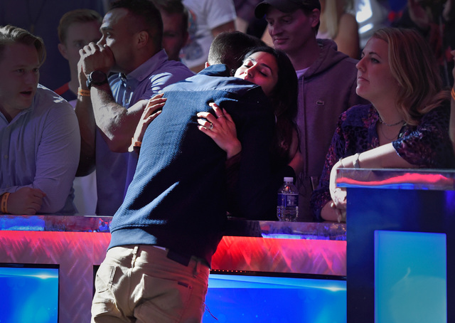 Gordon Vayo of San Francisco gets a hug from his fiancee after losing to Qui Nguyen of Las Vegas and taking second place at the final table at the 2016 World Series of Poker Main Event at the Rio  ...