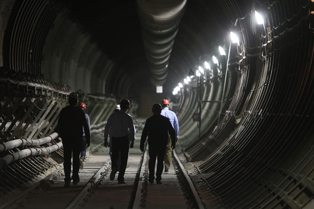 Congressional staff members, media and Department of Energy employees head for the south portal entrance during a congressional tour of the Yucca Mountain exploratory tunnel Thursday, April 9, 201 ...