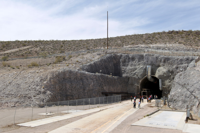 Congressional staff members, media and Department of Energy employees wait for congressmen to emerge from the north portal during a congressional tour of the Yucca Mountain exploratory tunnel Thur ...