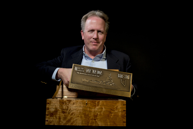 John Galloway, pilot and USS Nevada historian, holds a plaque that will be displayed in Pearl H ...