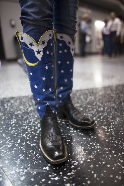Beth Mathis shows off her cowboy boots at the National Finals Rodeo at Thomas & Mack Center ...