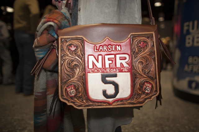 Alexis Minch shows off her bag at the National Finals Rodeo at Thomas & Mack Center on Sund ...