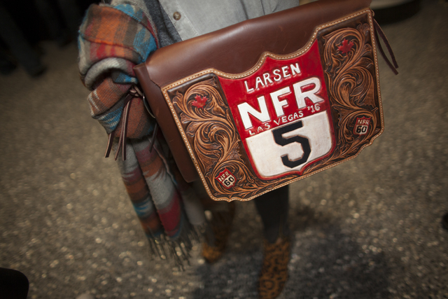 Alexis Minch shows off her bag at the National Finals Rodeo at Thomas & Mack Center on Sund ...