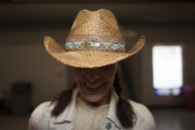 Ali Sherman shows off her hat at the National Finals Rodeo at Thomas & Mack Center on Sunda ...