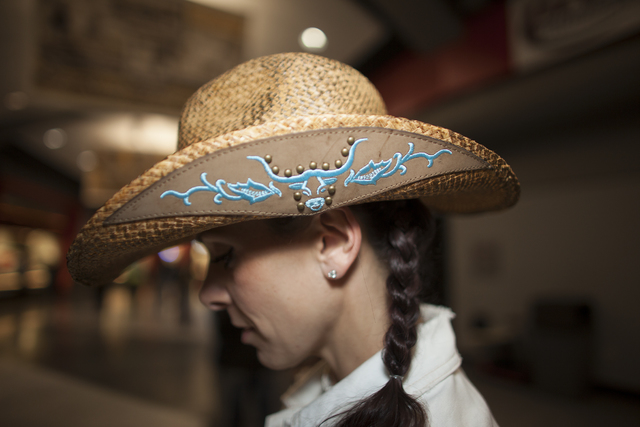 Ali Sherman shows off her hat at the National Finals Rodeo at Thomas & Mack Center on Sunda ...