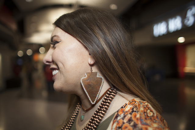 Jessica Thomas shows off her earring at the National Finals Rodeo at Thomas & Mack Center o ...