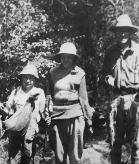 Patrick William Tierney poses with his mother, Marie, and father, John Gregory, in an undated photo from a fishing trip. (Tierney family)