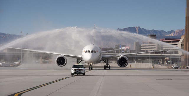 Hainan Airlines flight 7969, a Boeing 787 from Beijing, is greeted with a traditional water arches salute at McCarran International Airport in Las Vegas to inaugurate regular nonstop service from  ...