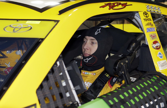 Race driver Kyle Busch sits in his car before NASCAR Sprint Cup Series Auto Racing qualifying Friday, Nov. 18, 2016, in Homestead, Fla. (Alan Diaz/AP)