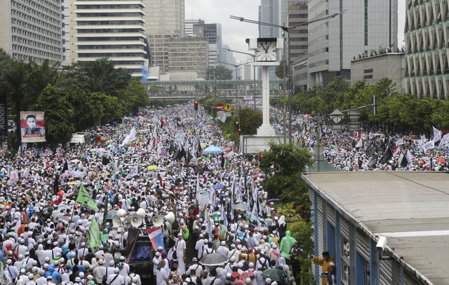 Indonesian Muslims march during a rally against Jakarta's minority Christian Governor Basuki "Ahok" Tjahaja Purnama who is being prosecuted for blasphemy, at the National Monument in Jakarta, Indo ...
