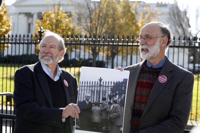 Michael, left, and Robert Meeropol, the sons of Ethel Rosenberg, pose similar to an old photograph of them, before they attempt to deliver a letter to President Barack Obama in an effort to obtain ...
